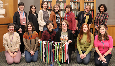 a group of librarians holding colorful ribbons banner